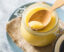 ghee-clarified-butter-jar-wooden-spoon-gray-table-top-view-copyspace-ghee-butter-have-healthy-fat-is-common-cooking-ingredient-many-indian-food-2-2-2
